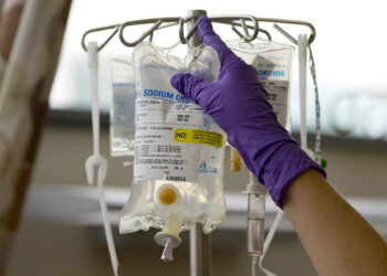 A nurse places a patient's chemotherapy medication on an intravenous stand at a hospital in Philadelphia on Aug. 4, 2015.  (AP Photo/Matt Rourke, File)