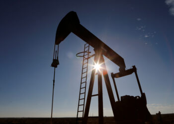 The sun is seen behind a crude oil pump jack in the Permian Basin in Loving County, Texas, U.S., November 22, 2019. Picture taken November 22, 2019.  REUTERS/Angus Mordant