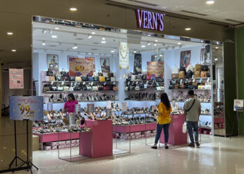 People shop at a Vern's outlet at a shopping mall in Kuala Lumpur, Malaysia, Monday, April 8, 2024. Vern’s Holdings, a Malaysian shoe company has apologized and stopped selling some of its footwear after some Muslims said the logo resembled the Arabic writing for the word God. (AP Photo/Vincent Thian)