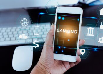 Businessman holding smart phone use word banking in hand with icon network connection on virtual screen dark background