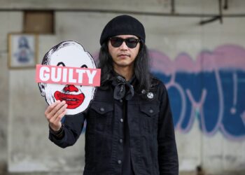 Malaysian artist and activist Fahmi Reza poses for a picture holding his artwork bearing an image of former Prime Minister Najib Razak, during an interview with Reuters, in Kuala Lumpur, Malaysia July 29, 2020. REUTERS/Lim Huey Teng