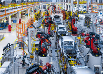 Assembly line production of new car. Automated welding of car body on production line. robotic arm on car production line is working