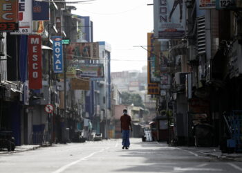FILE PHOTO: A man walks along a deserted road in Colombo, Sri Lanka, May 11, 2022. REUTERS/Dinuka Liyanawatte