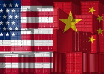 China US trade business concept as a Chinese USA tariff war and American tariffs as two opposing groups of cargo freight containers as an economic dispute or relationship over import and exports as a 3D illustration.