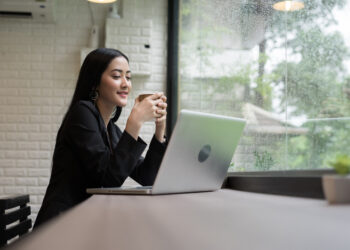 Young business woman have a break with coffee while working on laptop in the office